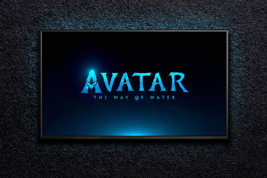 TV on black textured wall. TV screen playing Avatar the way of water trailer or movie. Moscow, Russia - November 3, 2022.