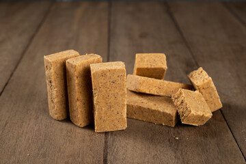 Stack of Brazilian Peanut Sweet called paçoca on a wooden desk