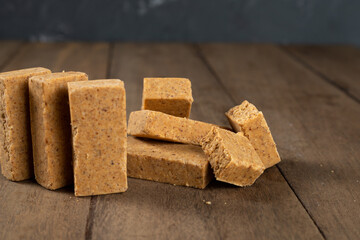 Stack of Brazilian Peanut Sweet called paçoca on a wooden desk