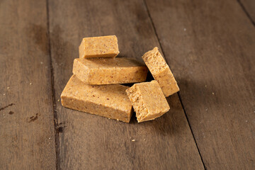 Stack of Brazilian Peanut Sweet called paçoca on a wooden desk