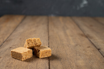 Stack of Brazilian Peanut Sweet called paçoca on a wooden desk