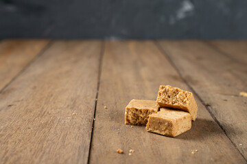 Stack of Brazilian Peanut Sweet called paçoca on a wooden desk