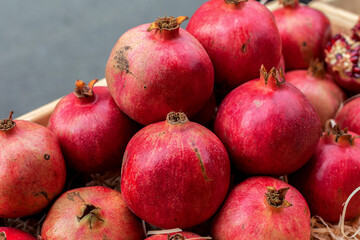 Pomegranate fruits. A vegetable counter at a street market. Trade in seasonal goods.