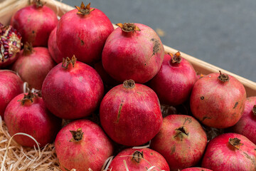 Pomegranate fruits. A vegetable counter at a street market. Trade in seasonal goods.