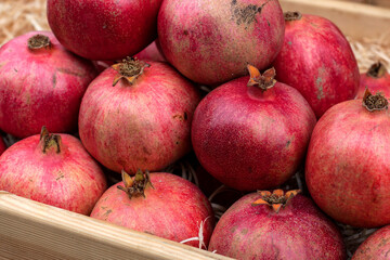 Fototapeta na wymiar Pomegranate fruits. A vegetable counter at a street market. Trade in seasonal goods.