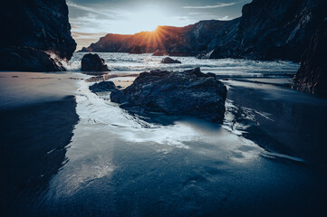 Sunset at kynance cove in Cornwall .