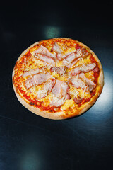 Delicious freshly baked pizza with tomato sauce and meat and cheese filling.