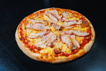 Delicious freshly baked pizza with tomato sauce and meat and cheese filling.