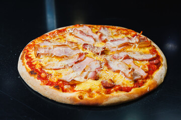 Delicious freshly baked pizza with tomato sauce and meat and cheese filling.