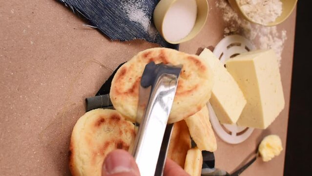 Hand taking an "Arepa" Clombian traditional food 