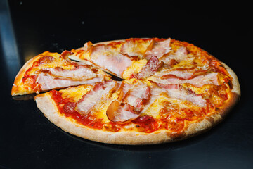 Delicious freshly baked pizza with tomato sauce and meat and cheese filling.