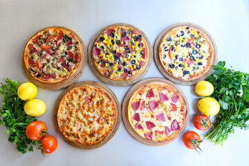 Traditional Turkish cuisine. Pizza, pita, pidesi, sucuk, hummus, kebab. Many dishes on the table. Serving dishes in restaurant. Background image. Top view, flat lay