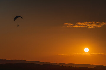 man flies a motor hang glider