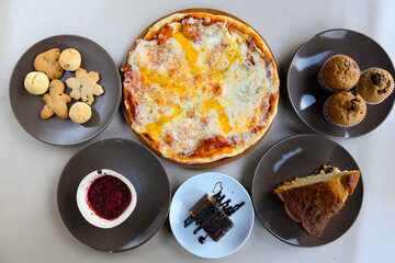 Traditional Turkish cuisine. Pizza, pita, pidesi, sucuk, hummus, kebab. Many dishes on the table. Serving dishes in restaurant. Background image. Top view, flat lay