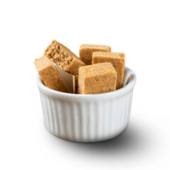 A bowl full of Brazilian Peanut Sweet called Paçoca isolated on white background