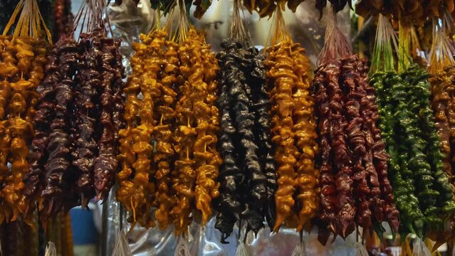 Traditional Georgian homemade candy sweets churchkhela with nuts, and juice in local food market. Tasty sweet food