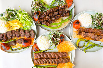 Traditional Turkish cuisine. Pizza, pita, pidesi, sucuk, hummus, kebab. Many dishes on the table. Serving dishes in restaurant. Background image. Top view, flat lay