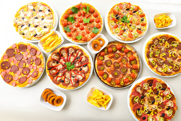 Traditional Turkish cuisine. Pizza, pita, pidesi, sucuk, hummus, kebab. Many dishes on the table. Serving dishes in restaurant. Background image. Top view, flat lay