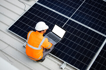 Installing solar power plant as sustainable energy source. Worker placing solar panel on the roof.