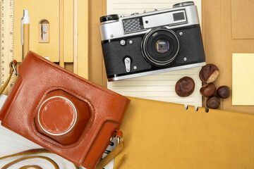 Old film camera with vintage orange and brown leather case