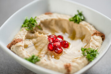 mutabel with pomegranate seeds served in dish isolated on grey background top view of arabic food
