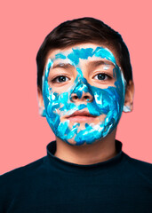 Funny children portrait  with face painting on color background