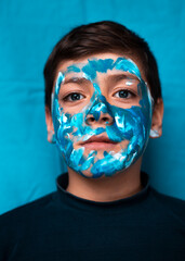 Funny children portrait  with face painting on color background