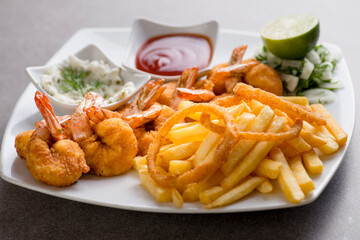 shrimps bani or fried shrimp with fries and tomato sauce served in dish isolated on grey background top view of arabic food