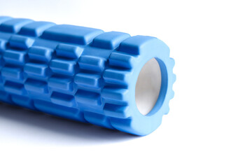 A blue foam massage roller isolated on a white background. Foam rolling is a self myofascial release technique. Gym fitness equipment.