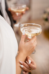 bride or girl in a white dress holding a glass of champagne