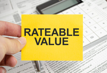 rateable value words on yellow sticker with pen and charts