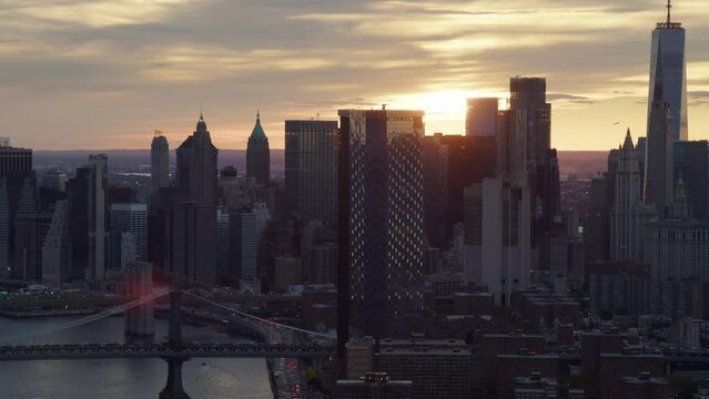 
Great Aerial View of Manhattan at Sunset. Backlight Shot with Brooklyn, Manhattan Bridge and FDR Drive full of Traffic. Famous Skyscrapers in New York City. High Quality Footage Shot from Helicopter.
