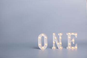 background texture empty space for baby with letters one with backlight. Celebratory background design for birthday celebration. One year birthday party decorations.