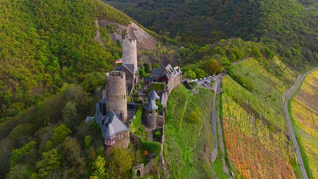 Burg Thurant at the Mosel vineyards nestled in the hills. Aerial Drone Shot of Thurant Castle the Moselle River, Germany