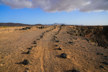 Walking trail at the top of the cliffs overlooking the Playa de la Escalera (Staircase Beach) on the western coast of Fuerteventura in the Canary Islands, Atlantic Ocean, Spain