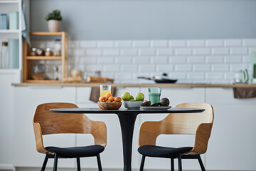 Background image of minimal kitchen interior with elegant wooden chairs and table set, copy space