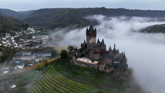 Beautiful 11 century Castle in Cochem, by the Mosel River, Rheinland-Palatinate, Germany. Aerial Drone Foggy Morning