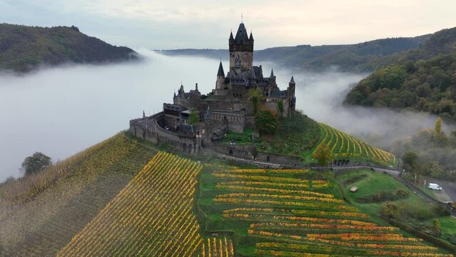 Beautiful 11 century Castle in Cochem, by the Mosel River, Rheinland-Palatinate, Germany. Aerial Drone Foggy Morning