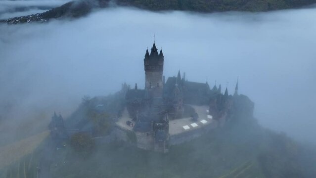 Beautiful 11 century Castle in Cochem, by the Mosel River, Rheinland-Palatinate, Germany. Aerial Drone Foggy Morning