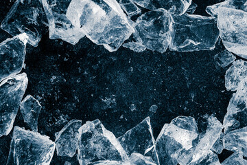 Ice cubes crush on black background. Chill backdrop. Frame border, made of ice. - 551918327