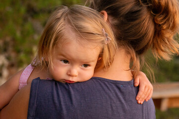 Mom and daughter are hugging at sunset. Beautiful picture of motherhood