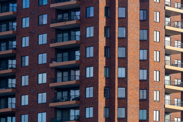Fototapeta na wymiar Brick exterior luxury apartment building with balconies, new construction, pattern, downtown Columbus Ohio