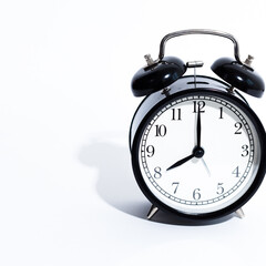 Old style alarm clock isolated on white