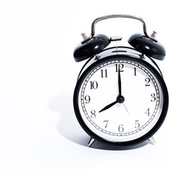 Old style alarm clock isolated on white