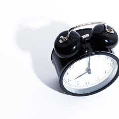 Old style alarm clock isolated on white