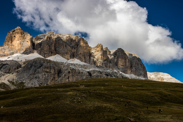 Fototapeta na wymiar Clouds over Selle Pass in Dolomites