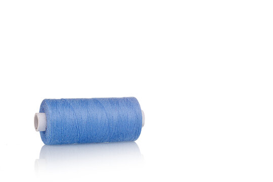 a skein of threads of blue color macro on a white background close up