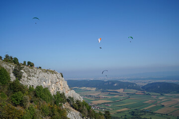 Some Paragliders at Hohe Wand in Lower Austria, Austria. Sunny Day with clear blue sky. Space for text