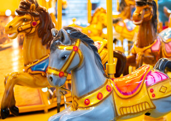 Fototapeta na wymiar merry go round carousel. Horses in a colourful carousel with lights