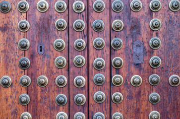 Old and antique door made of wood with metal details and black lock